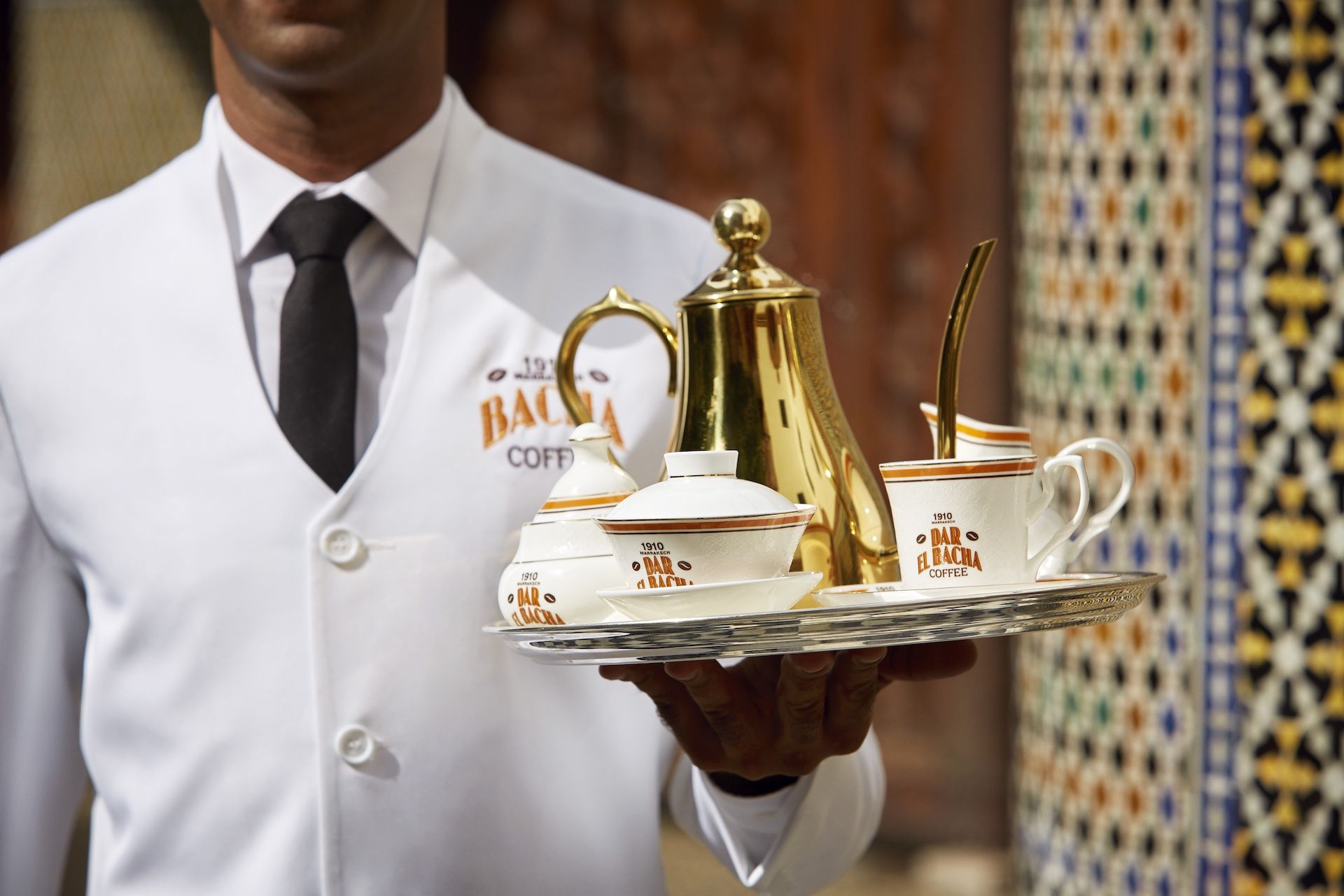 Bacha Coffee Master at Dar el Bacha, Marrakech, serving with Bacha Coffee Pot in Gold and Heritage Collection.